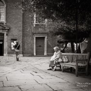 Elderly women looks at a youth in the churchyard.