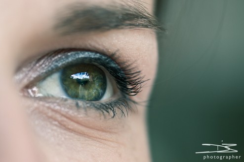 An macro of an eye, with a blured green backdrop