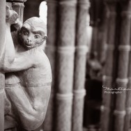 A gargoyle monkey on a column.