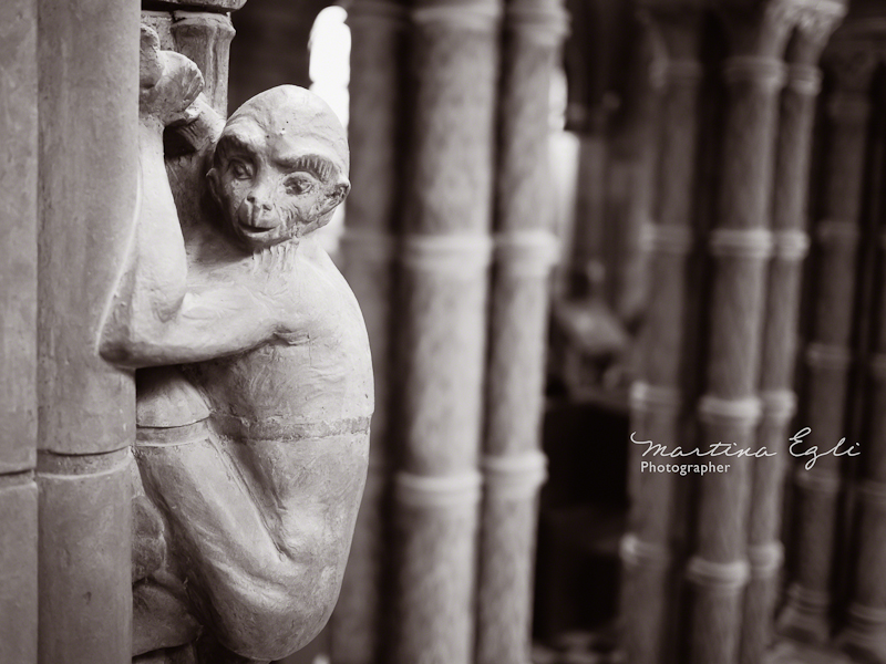 A gargoyle monkey on a column.