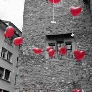 Heart shaped balloons float through the air.