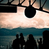 Silhouette of people waiting at the dock.