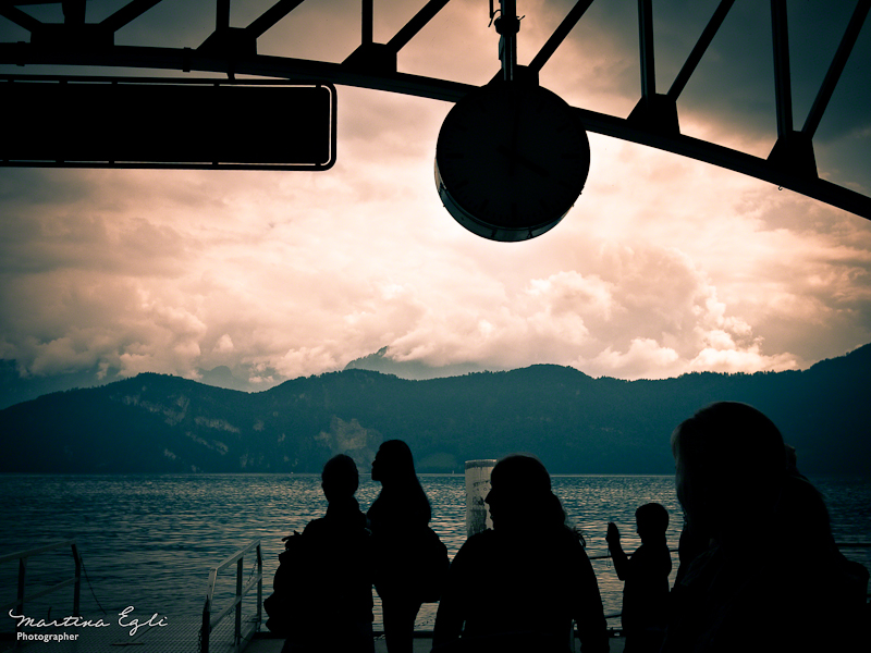 Silhouette of people waiting at the dock.