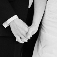 Newlyweds holding hands.