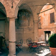 An Italian café with a mural on the wall.