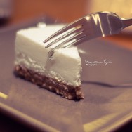 A slice of New York Cheesecake and a fork.