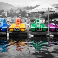 Four pedalos on a lake.