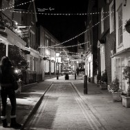 A street decorated with christmas lights.