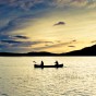 Golden Moment Two people in a canoe in Loch Lomond.