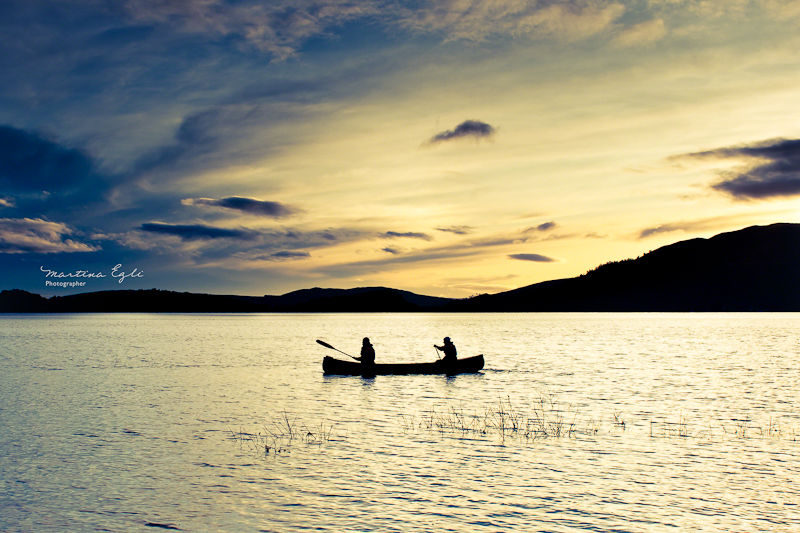 Golden Moment Two people in a canoe in Loch Lomond.