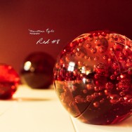 Three spheres made out of red glass.