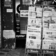 A newspaper stand filled with newspapers from all over the world.