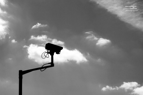 A silhouette of a cctv camera