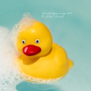 A rubber duck with bubbles on his head.