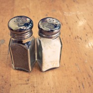 Salt and pepper shaker on a wooden table.