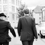 The groom and best man walk down the street.
