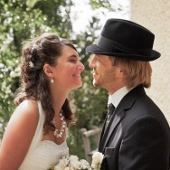 The Bride leans in to kiss her Groom.