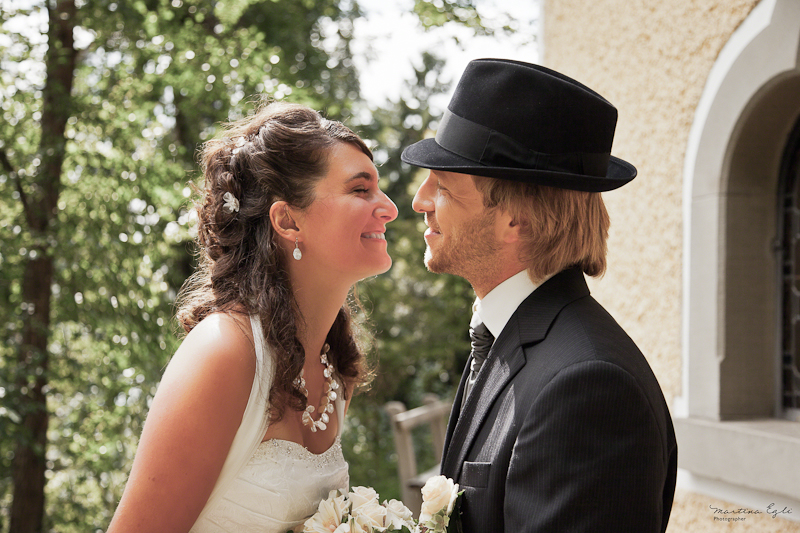 The Bride leans in to kiss her Groom.