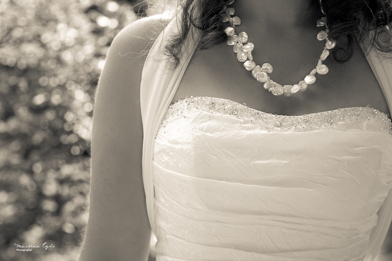 bridal details A detail of the bride's dress and her necklace in black and white.