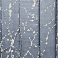 A wodden fence painted blue covered with plants.