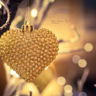 A golden heart hanging on a tree as a Christmas decoration.
