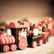 A wooden toy train with Santa Claus.