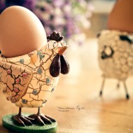 A boiled egg in an eggcup in the shape of a chicken