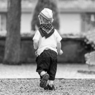 A young boy, dressed as a sailor enjoys his freedom.