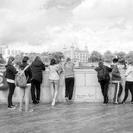 A group of teenagers looking at the Tower of London.