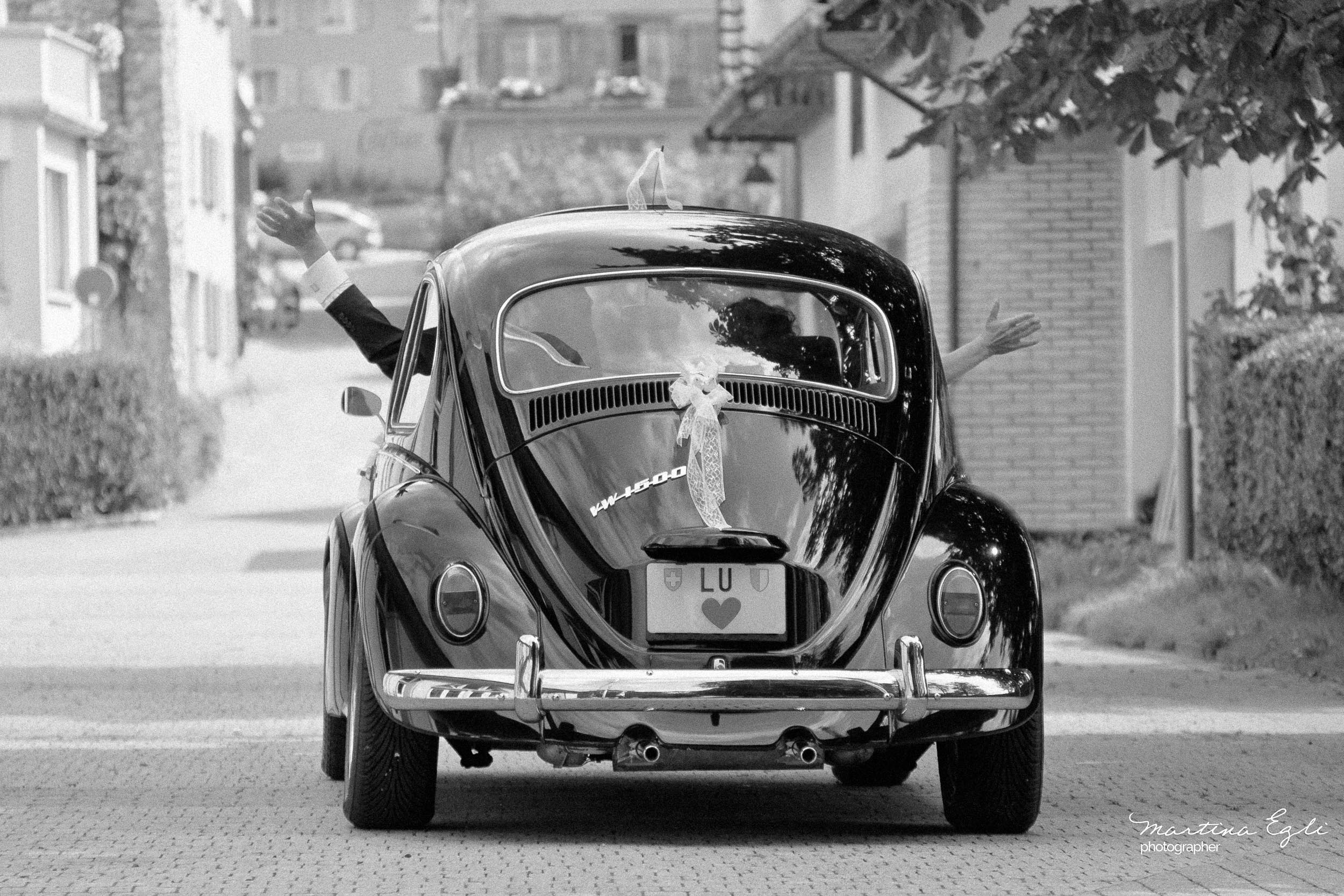 The Bride and Groom depart in their love-bug