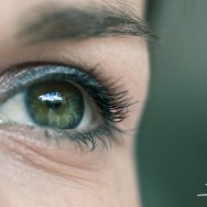 An macro of an eye, with a blured green backdrop