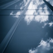 Blue Image of clouds reflected in a glass building