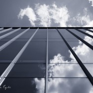 Blue Image of clouds reflected in a glass building