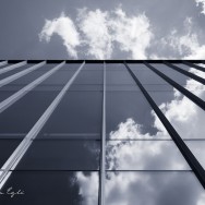Blue Image of clouds reflected in a glass building