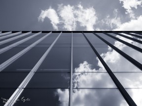 Blue Image of clouds reflected in a glass building