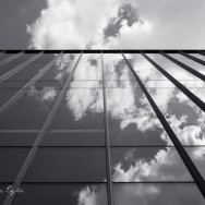 Image of clouds reflected in a glass building