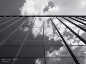 Image of clouds reflected in a glass building