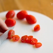 Person slicing tomatoes