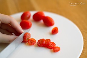 Person slicing tomatoes
