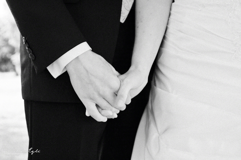 Newlyweds holding hands.