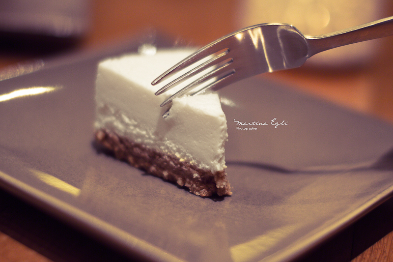 A slice of New York Cheesecake and a fork.