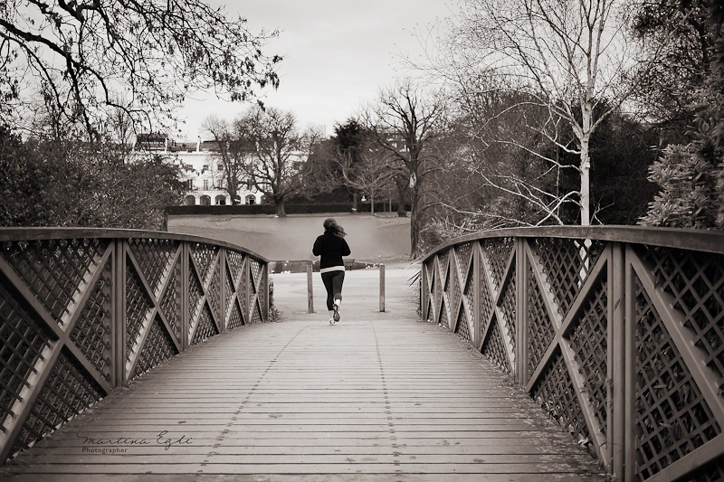 A jogger crossing a bridge.