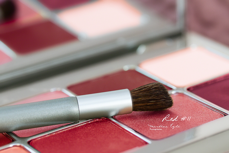 A box of eye shadows in various shades of red.