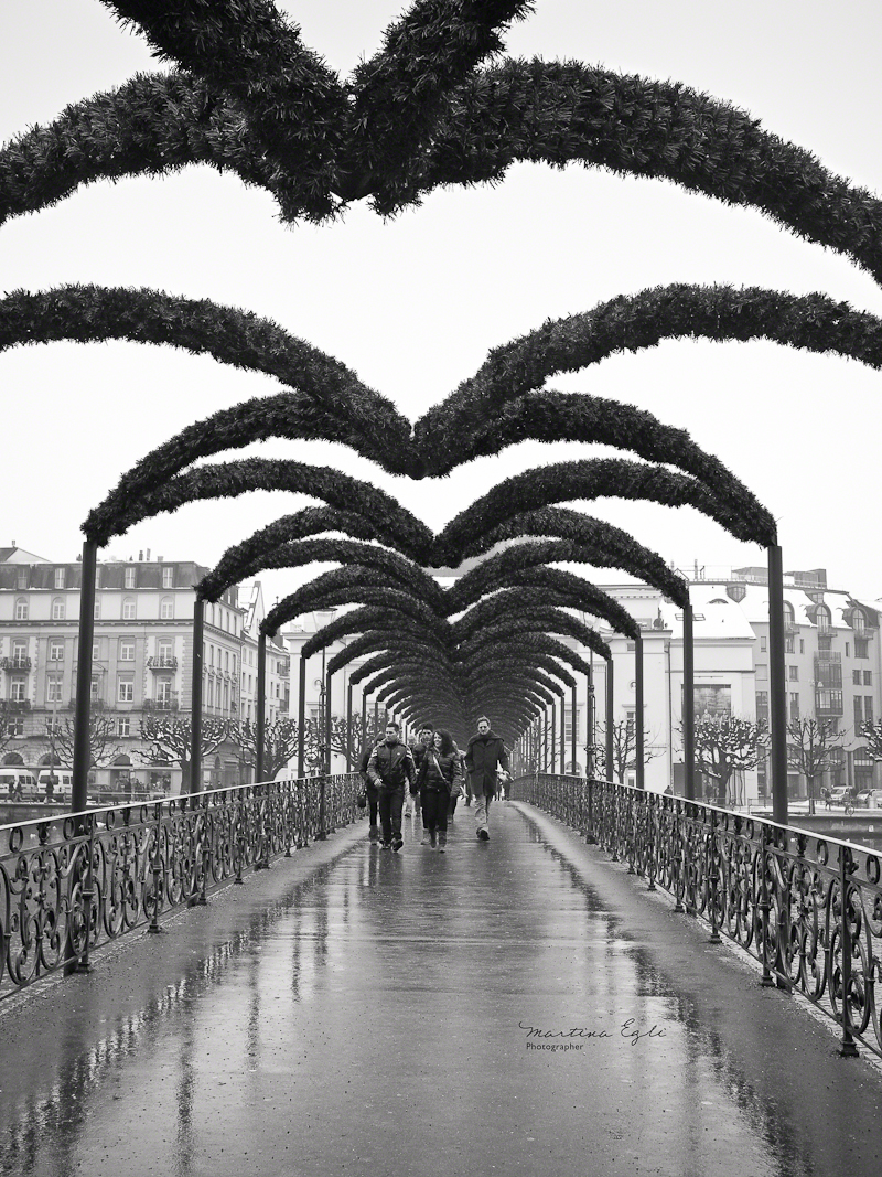 Walkers on a bridge in Luzern, Switzerland.