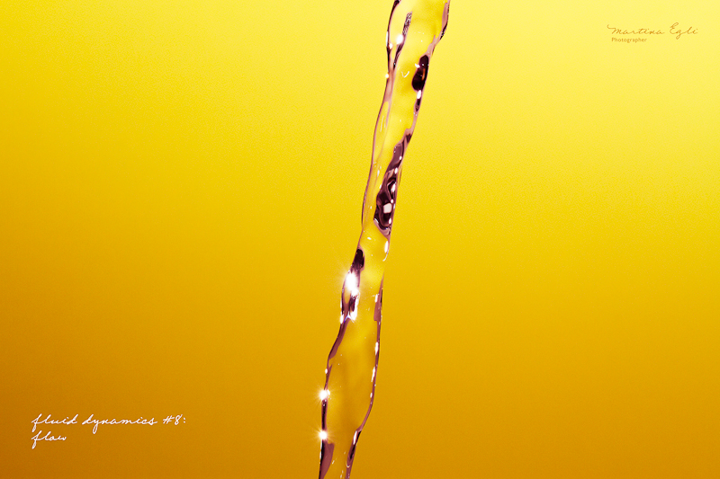 A stream of water over a yellow-orange backdrop