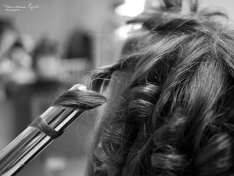 A woman has her curled in preparation for her wedding.