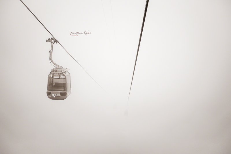 A cable car disappering into the mist at Mount Pilatus in Switzerland.