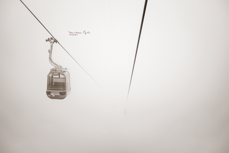 A cable car disappering into the mist at Mount Pilatus in Switzerland.