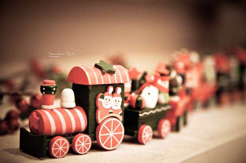 A wooden toy train with Santa Claus.