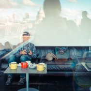 A man is having a coffee at the Tate Modern.